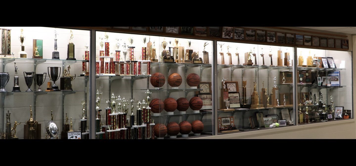 Trophy Case containing  trophies and basketballs